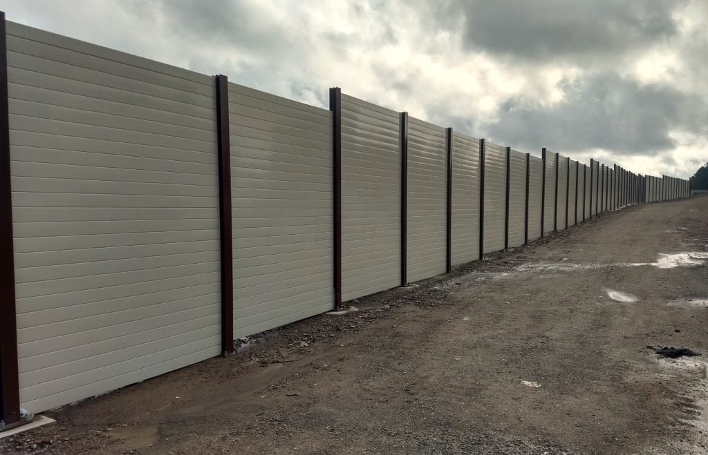 Wide view of non-perforated side of Silent-Protector sound barrier wall