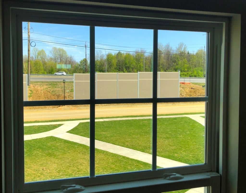 View of noise barrier wall section through townhome window