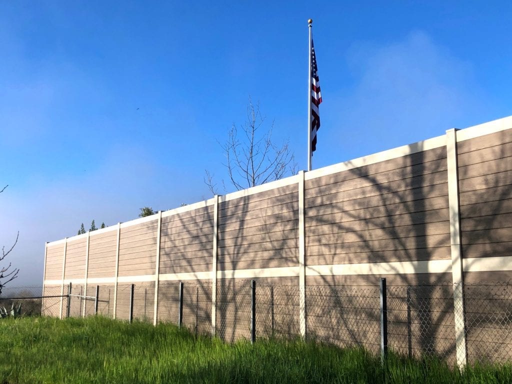 View of sound barrier wall along Flying Flags RV Resort