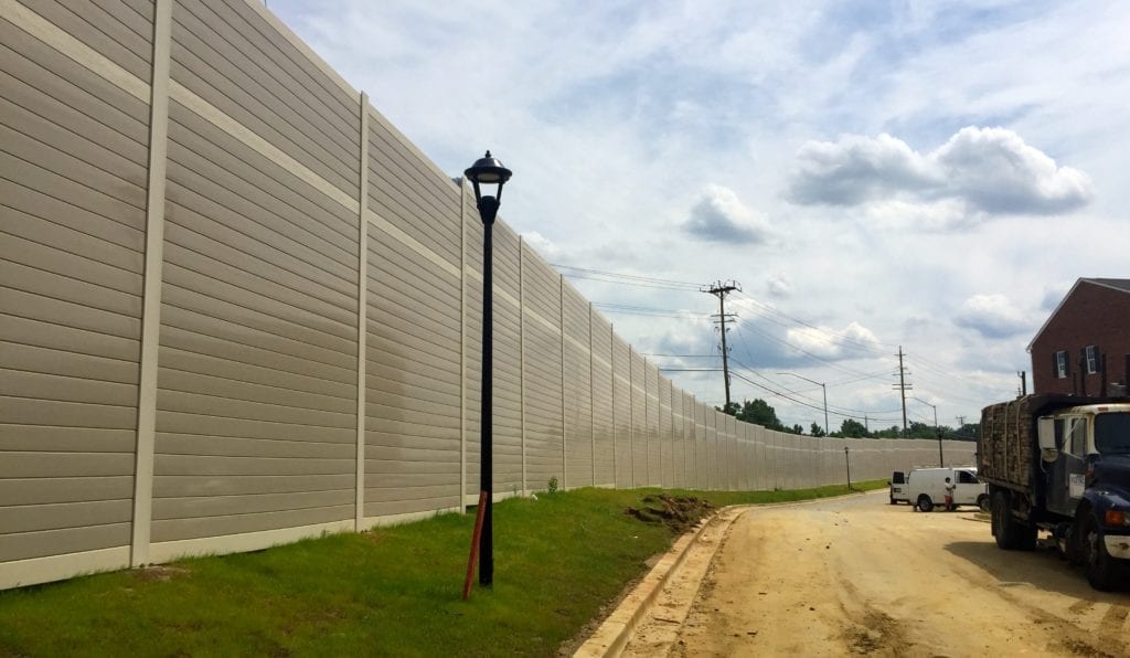 Gracefully curving noise barrier wall with townhomes