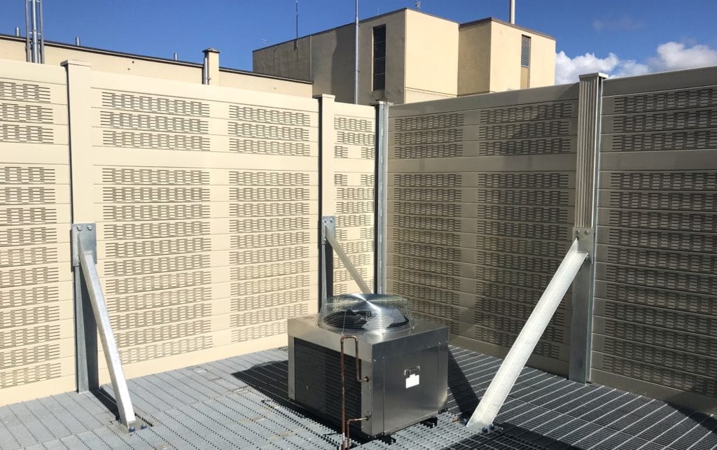 Interior view of rooftop-mounted sound barrier wall equipment enclosure