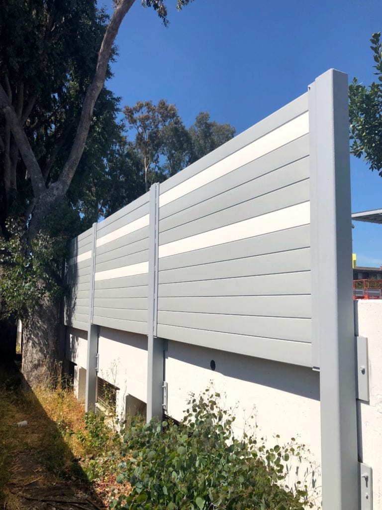 Exterior detail view of sound barrier wall mounted to parking structure