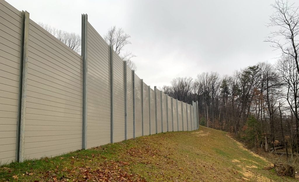 Wide exterior view of residential noise barrier wall