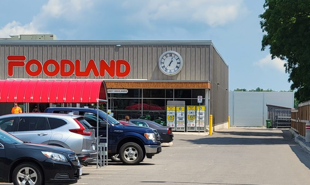 Front view of Foodland with sound barrier wall in background