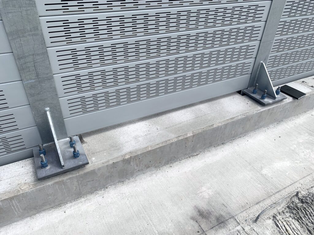 Close-up of noise barrier wall mounted to LRT guideway