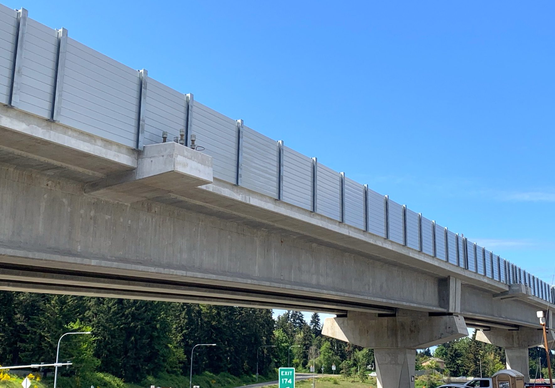 Looking up at noise barrier wall on LRT guideway