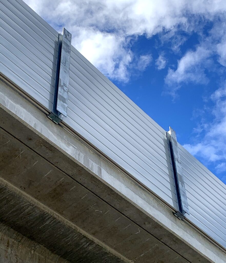 Looking up at sound barrier wall on LRT guideway