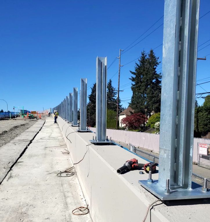 Noise barrier wall stanchions on LRT guideway