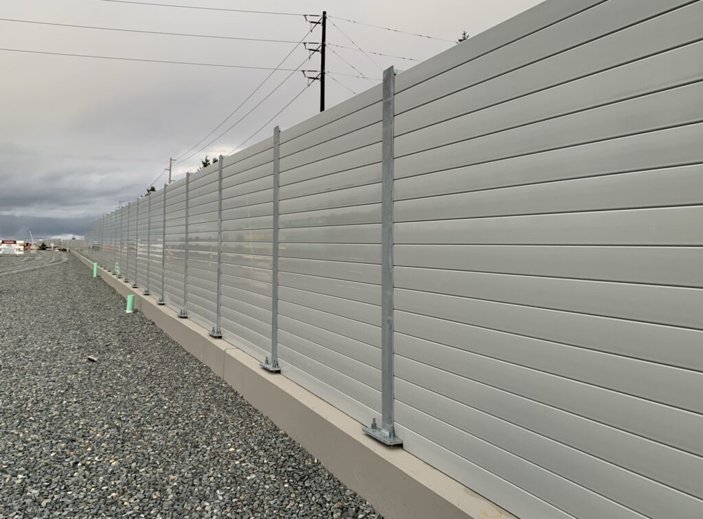 Wide view of LRT sound barrier wall on retaining wall