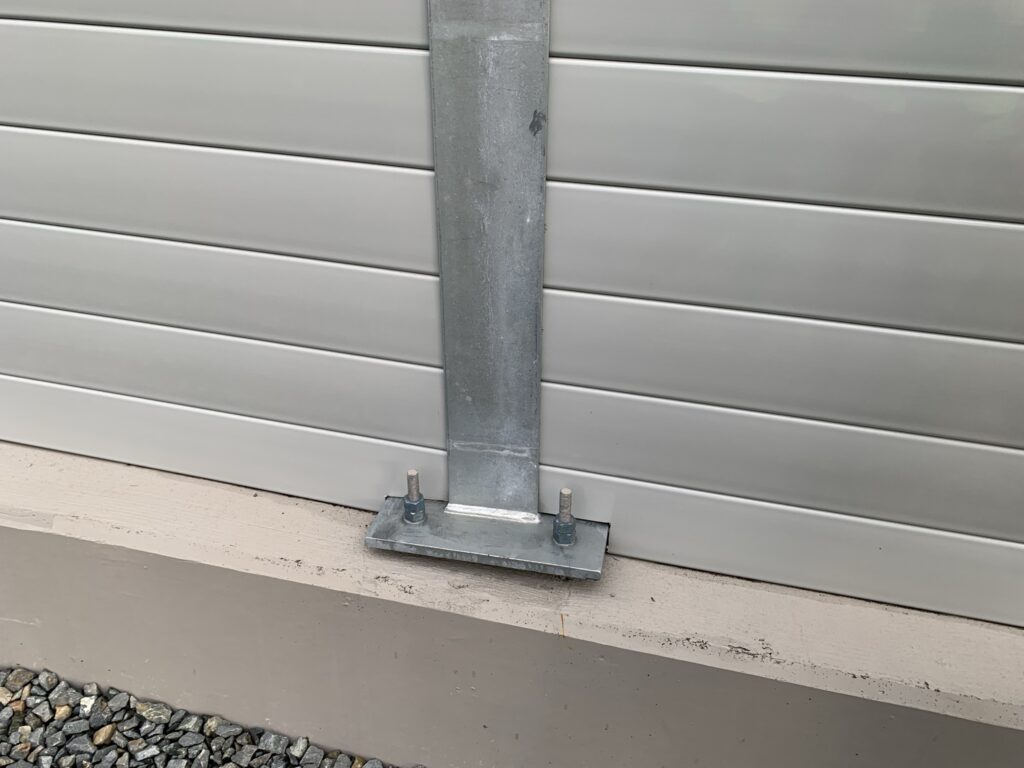 : Close view of LRT sound barrier wall on retaining wall