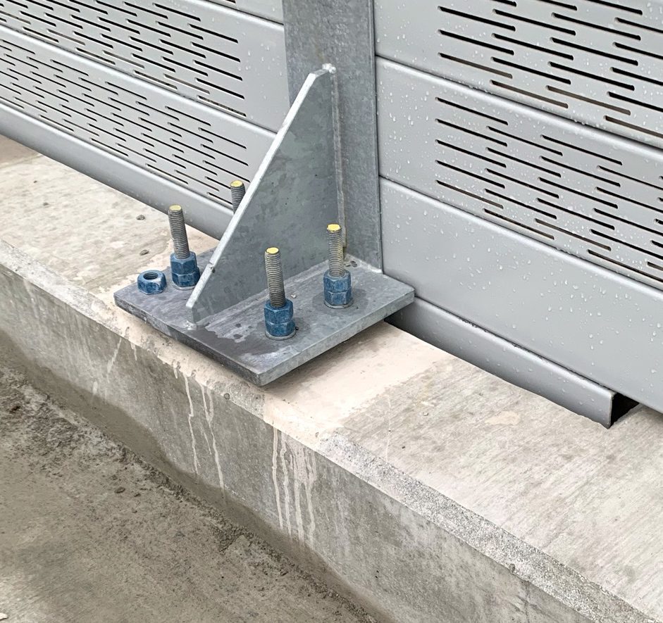 Close-up of noise barrier wall flange-mount on LRT guideway