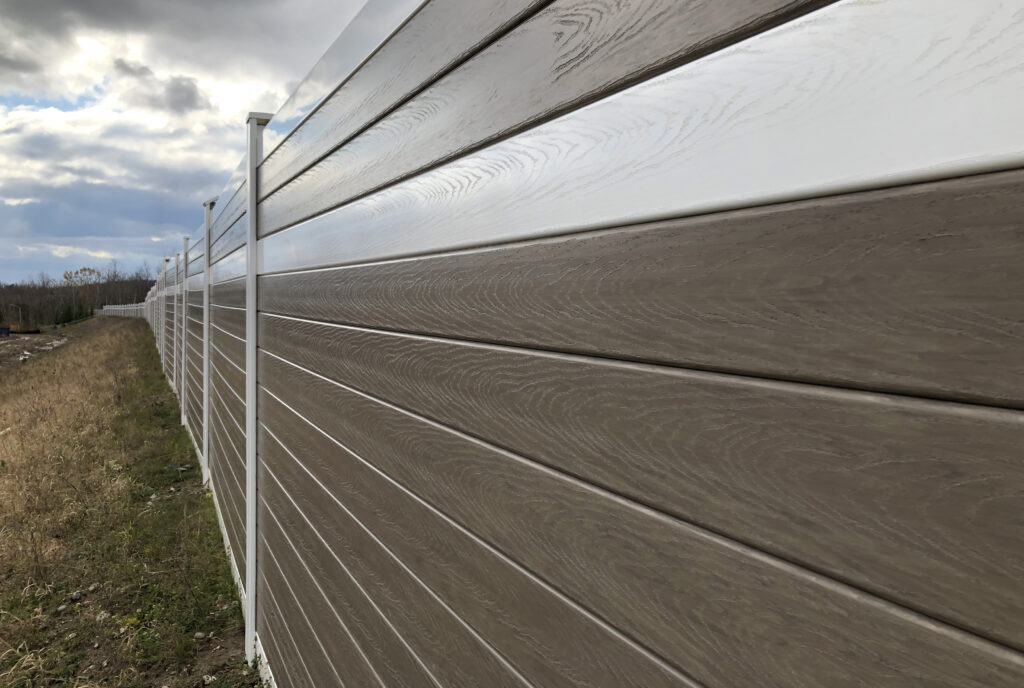 Image of noise barrier wall with woodgrain finish