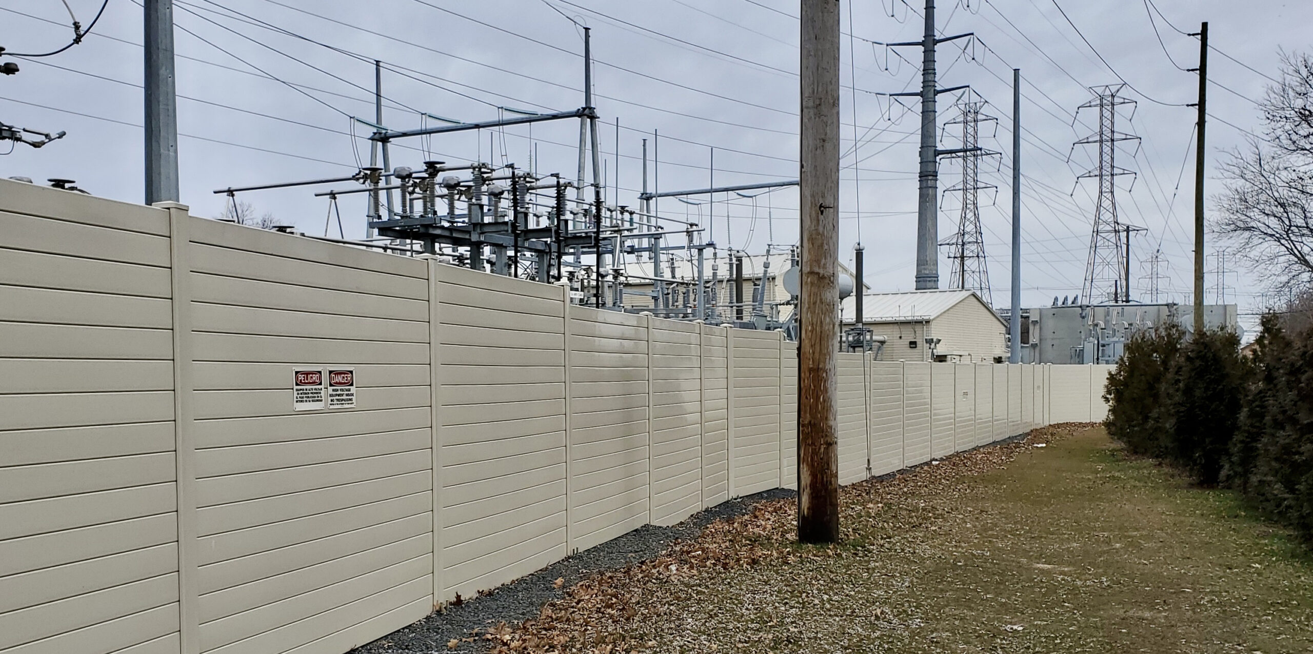 Wider view of electrical switching station noise barrier wall