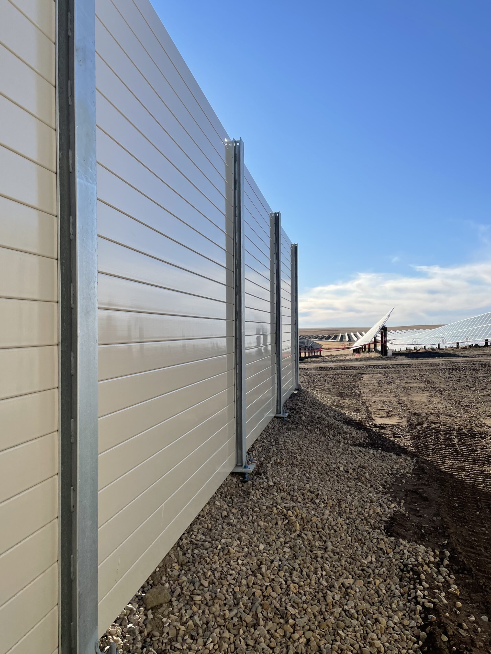Close-angled view of solar farm noise barrier wall