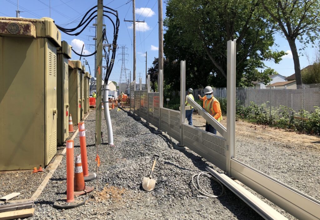 Switching station noise barrier wall panel installation begins