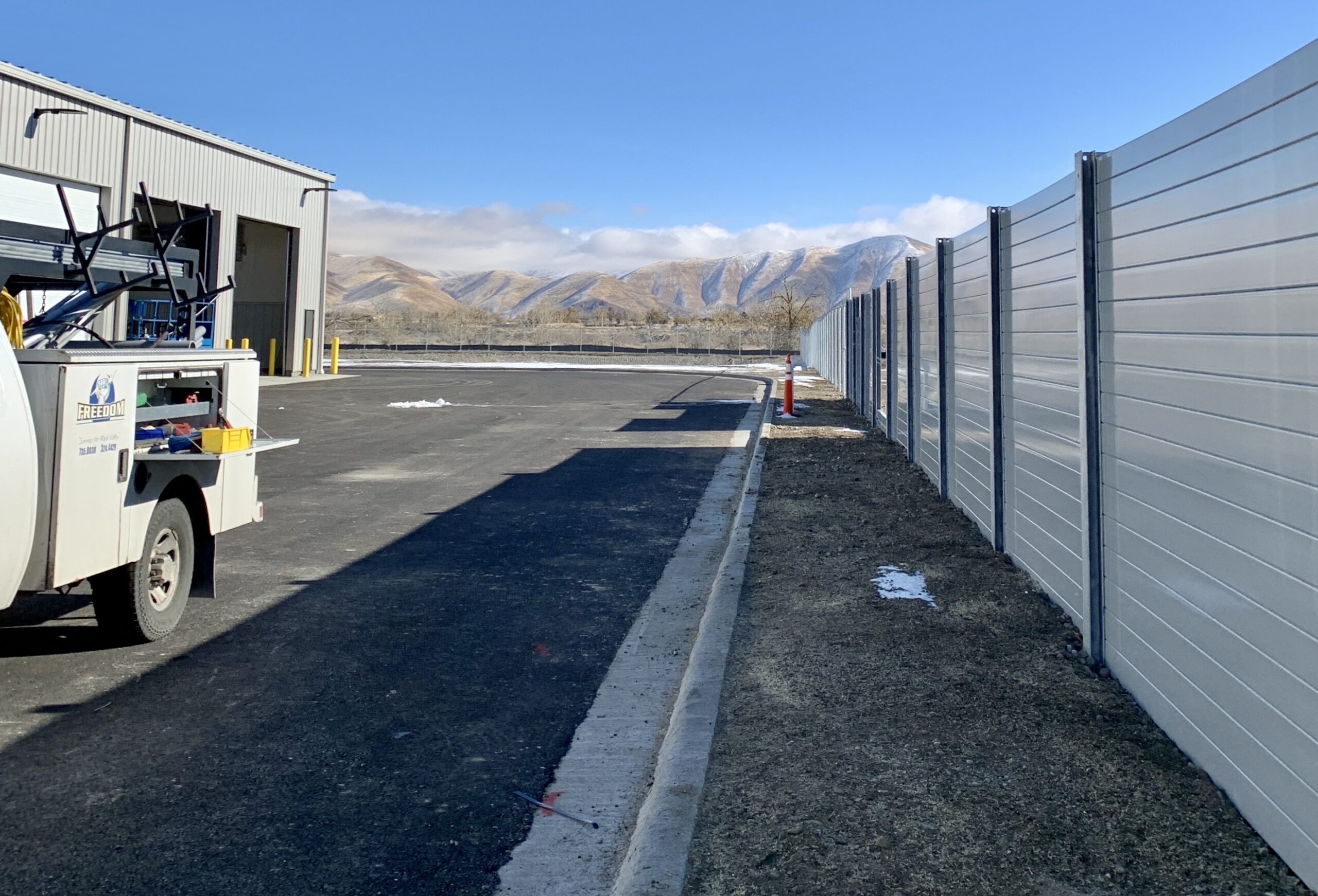 Wide view of sound barrier wall at FedEx logistics center