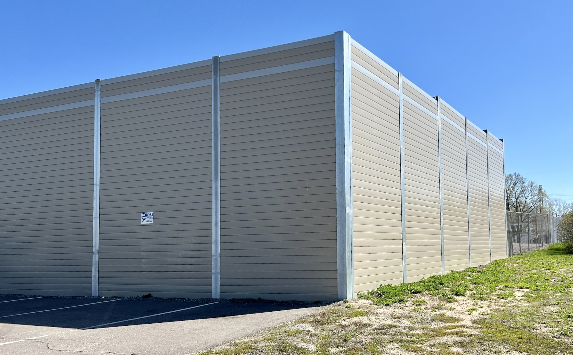 Corner view of sound barrier wall adjoining FedEx logistics center