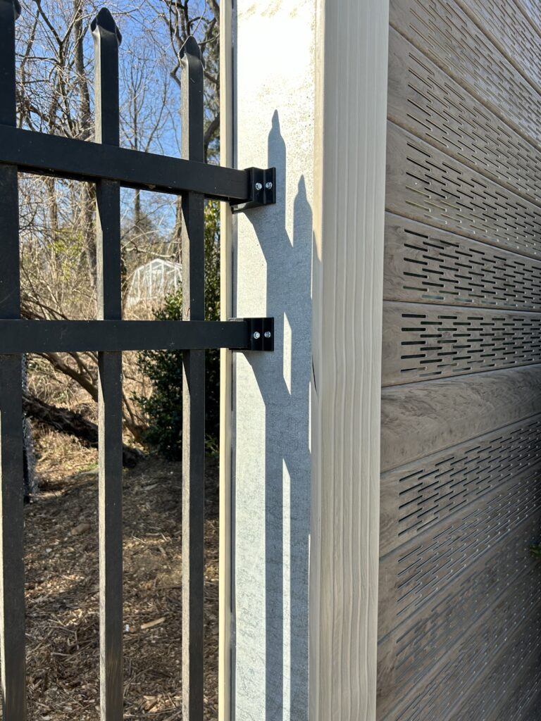 View of fence abutting sports field noise barrier wall