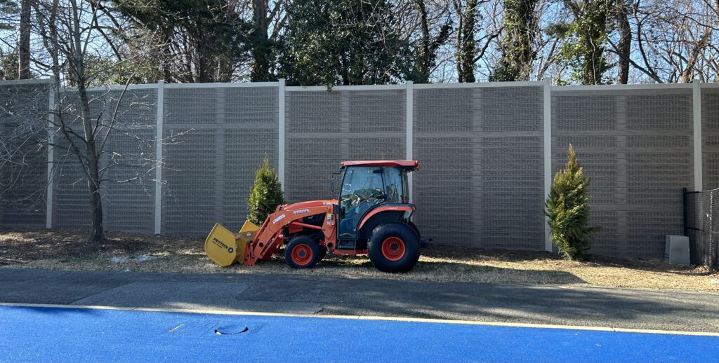 Wide view of sports field noise barrier wall