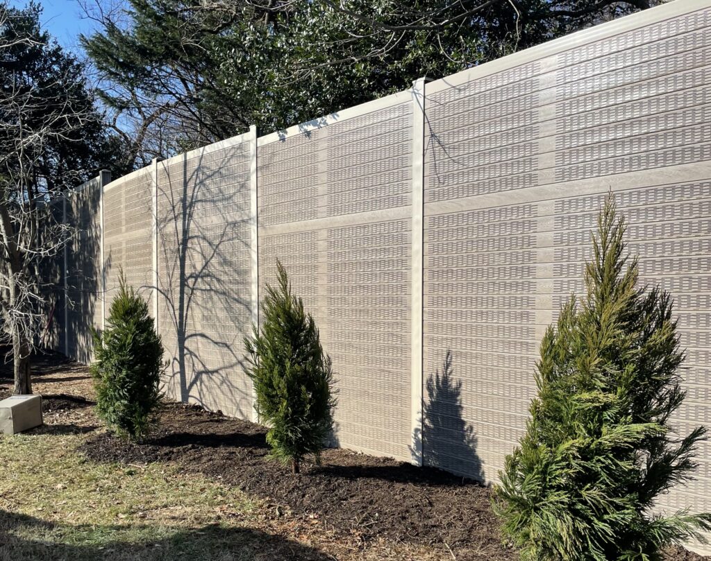 Angled view of sports field noise barrier wall