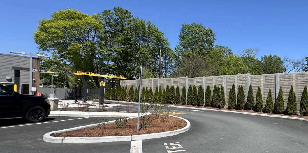 Wide view of Chick-fil-A site with noise barrier wall