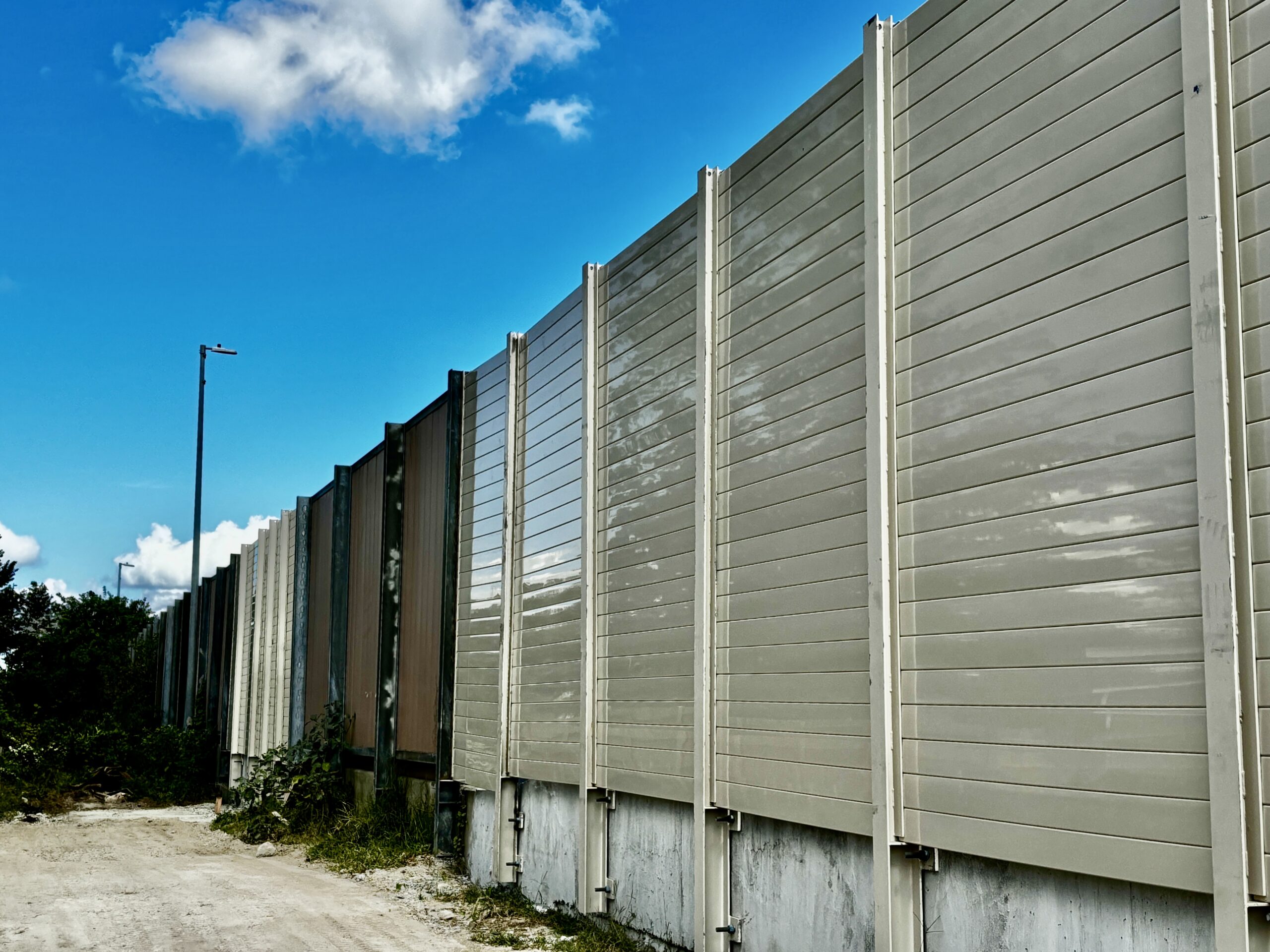 Wide view of structure-mounted sound barrier wall