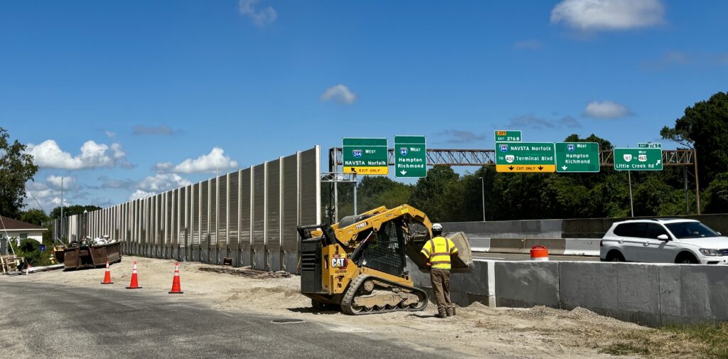Wide view of highway sound barrier wall installation