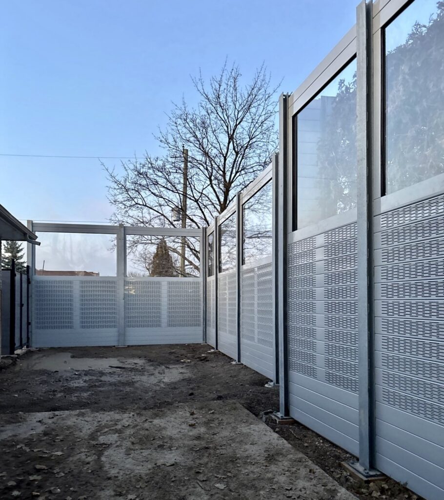 Wide view of sound barrier wall for-dog-daycare-yard